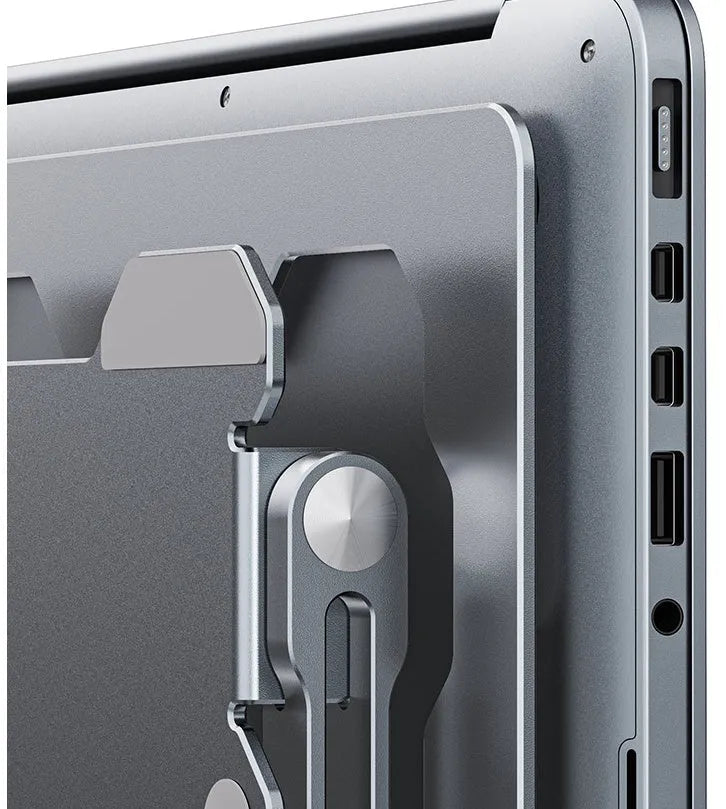 Grey aluminium adjustable and foldable laptop stand on a wooden desk.