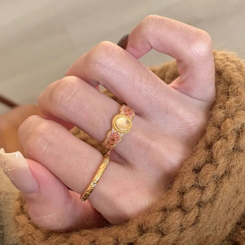 Open mouth geometric ring with pink crystal enamel accents on gold-plated copper band