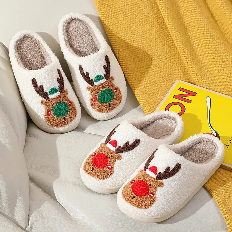 Christmas winter home slippers in red with plush upper and anti-slip sole on a wooden floor