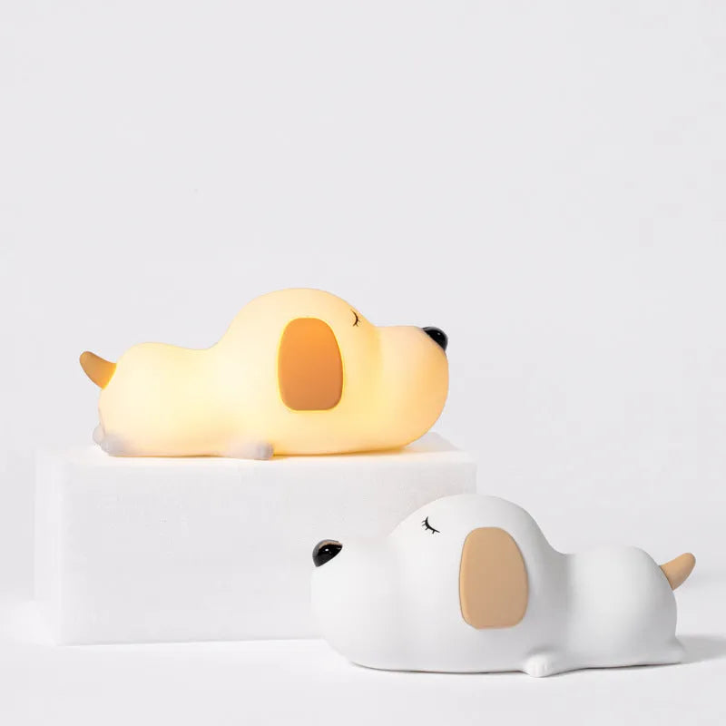Cartoon dog design USB-charging silicone night lamp in two colours on a surface.