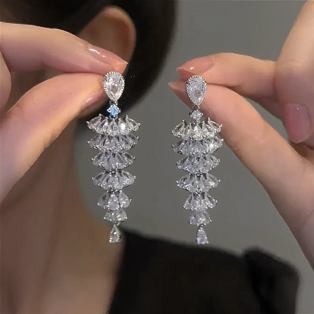 Women's silver pagoda Christmas tree drop earrings with sparkling zircon details on copper.