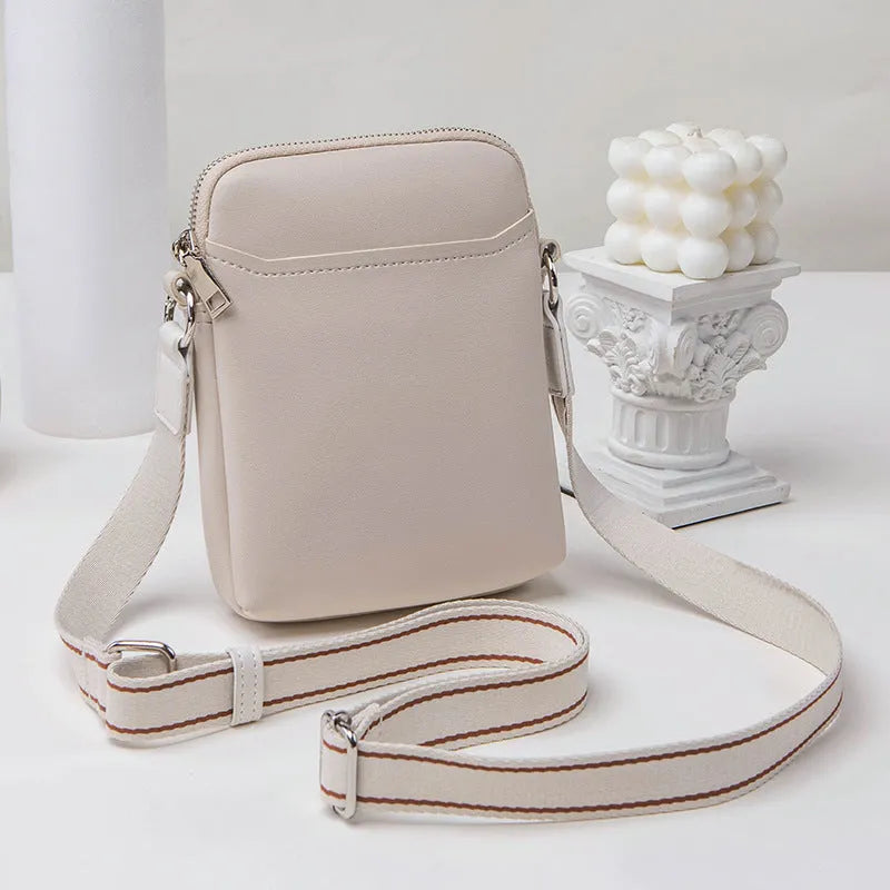 Solid colour PU leather crossbody shoulder bag for women with adjustable strap.
