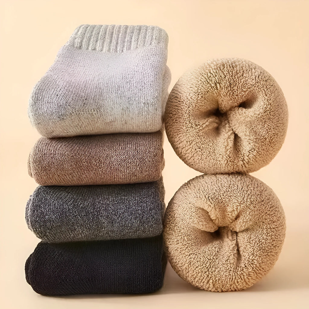 Pair of thick, solid-colour men's winter wool socks showing reinforced heel and midsole cushioning.