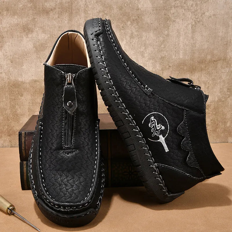 Men's black slip-on loafers with round toe and rubber sole on a white background.