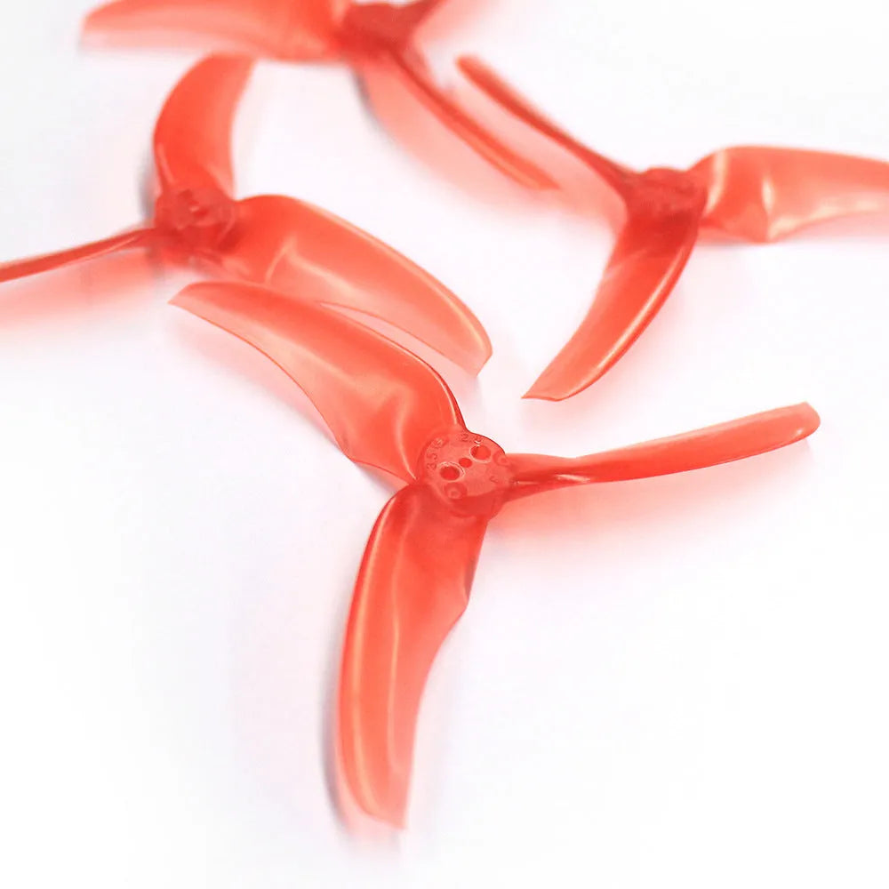 Four red plastic machete screw paddle blades, 90mm diameter, 2.8in pitch, on white background