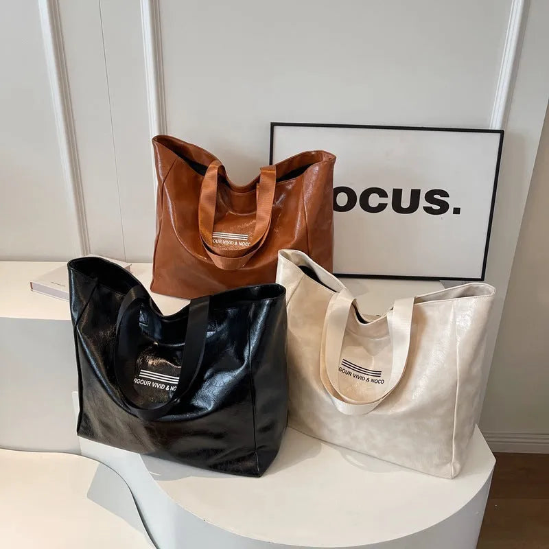 Large capacity PU tote bag for women in solid black, beige or brown, waterproof shoulder handbag for daily and travel use.