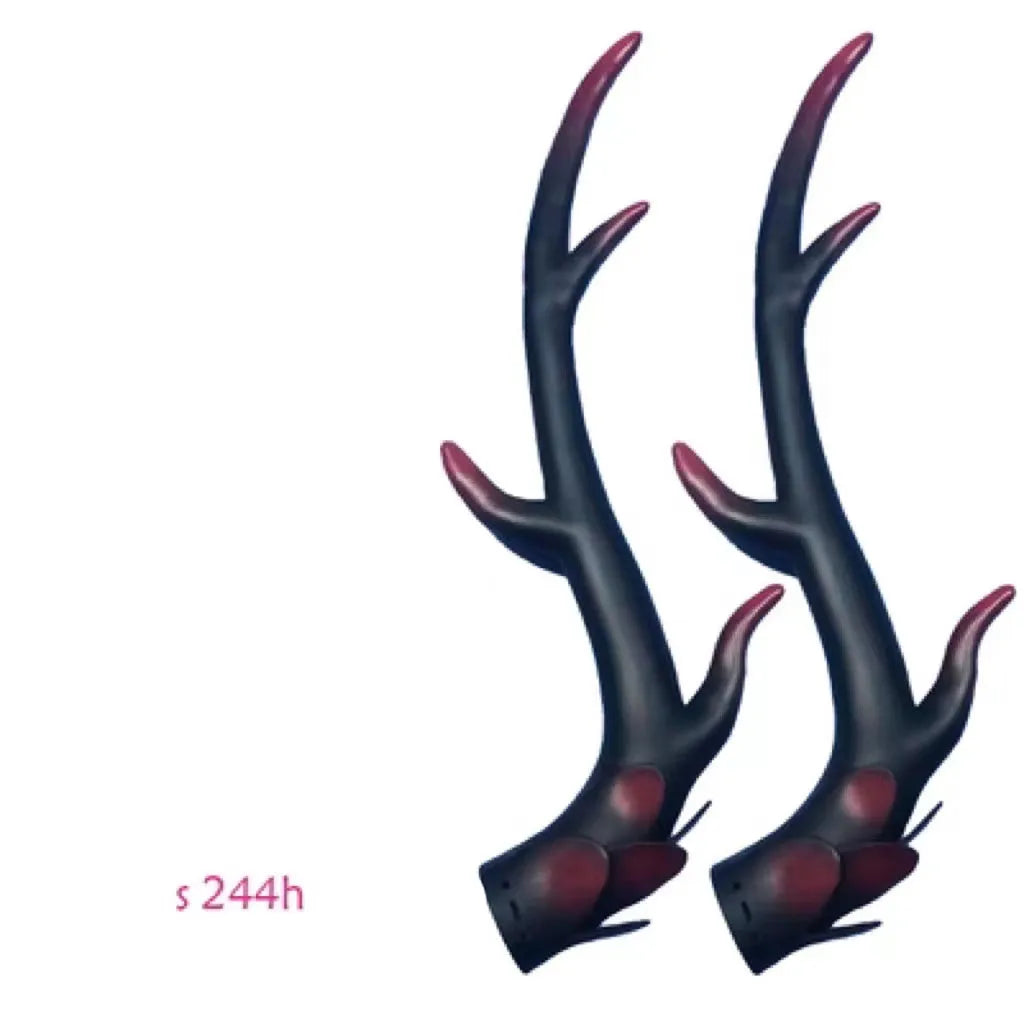 A pair of black resin dragon horn decorations for motorcycle helmet customisation, showing curved shape and mounting base.
