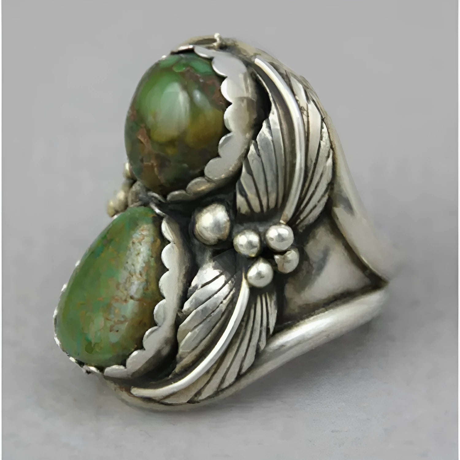 A geometric turquoise ring with a silver-toned alloy band and a retro design.