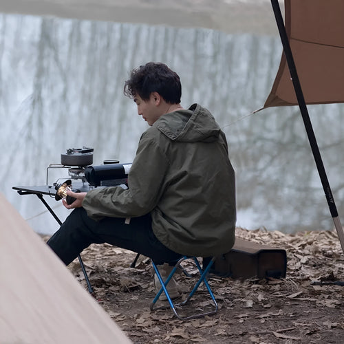 Black aluminium alloy folding camp stool shown in open and folded positions.
