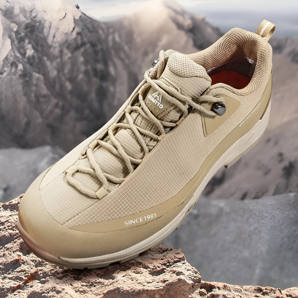 Men's low-top mountain climbing hiking boots in black with lace-up front and non-slip rubber sole.