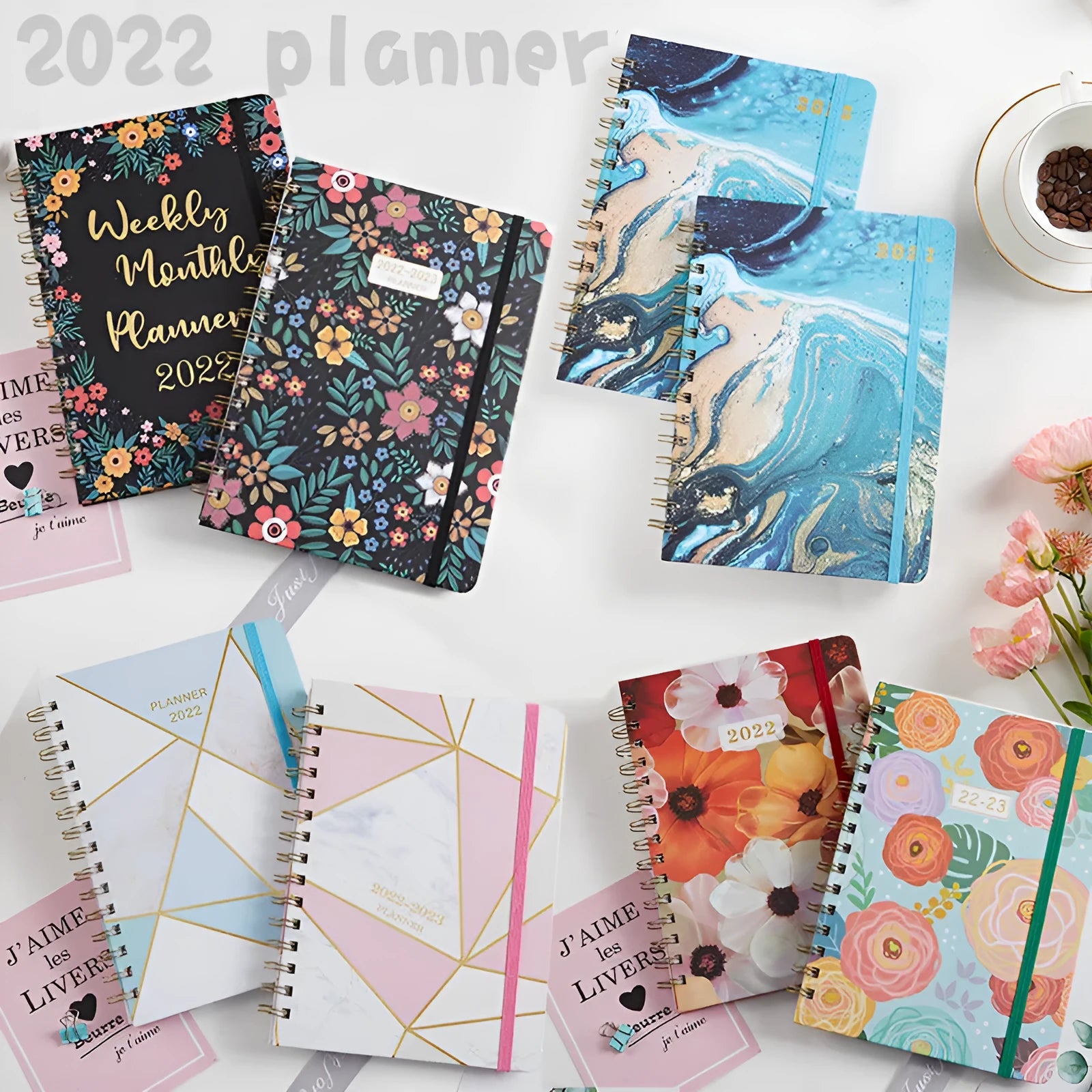A5 spiral notebook with colourful floral cover design, lying open on a flat surface.