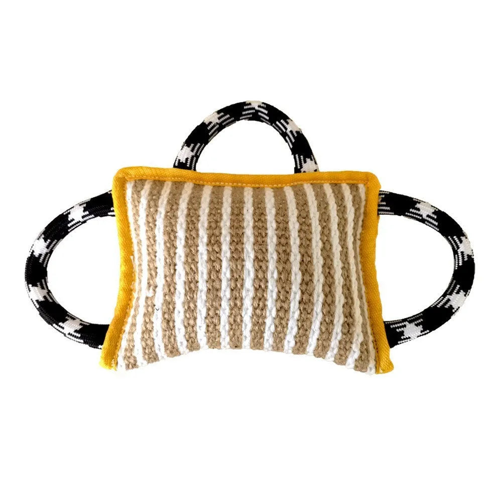Dog tug of war toy with blue jute bite pillow and three rope handles on a wooden floor.