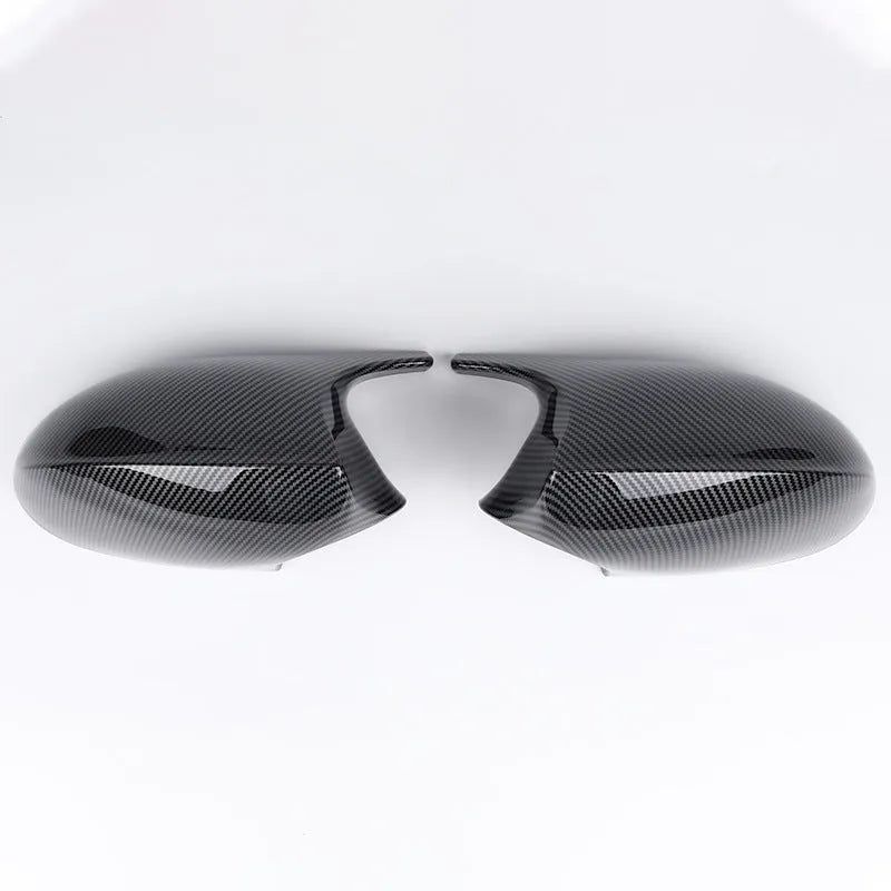 A pair of black ABS plastic rearview mirror shells for a BMW 3 Series E90 car.