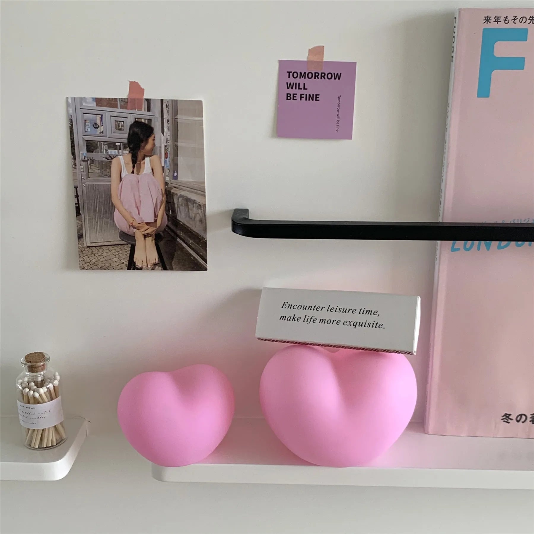 White and pink vinyl atmosphere lamp in trumpet and tuba shapes on a bedside table.