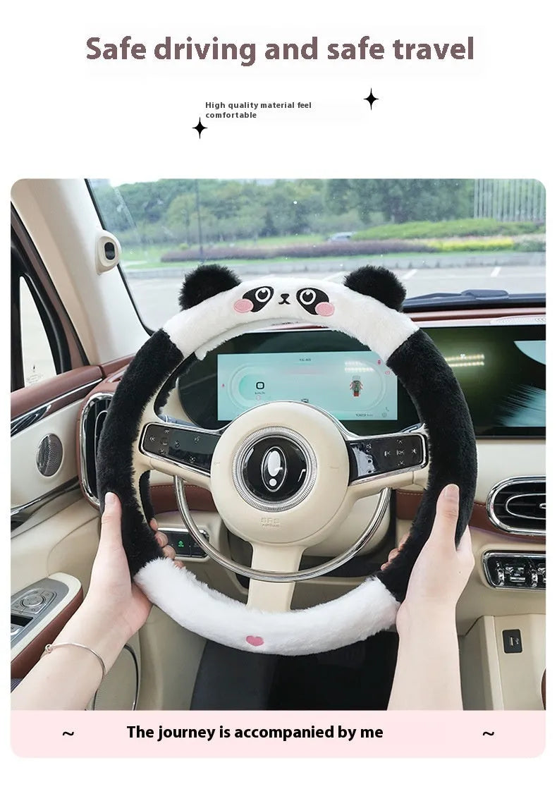 Plush rabbit fur style steering wheel cover with embroidered panda design, fitted on a car wheel