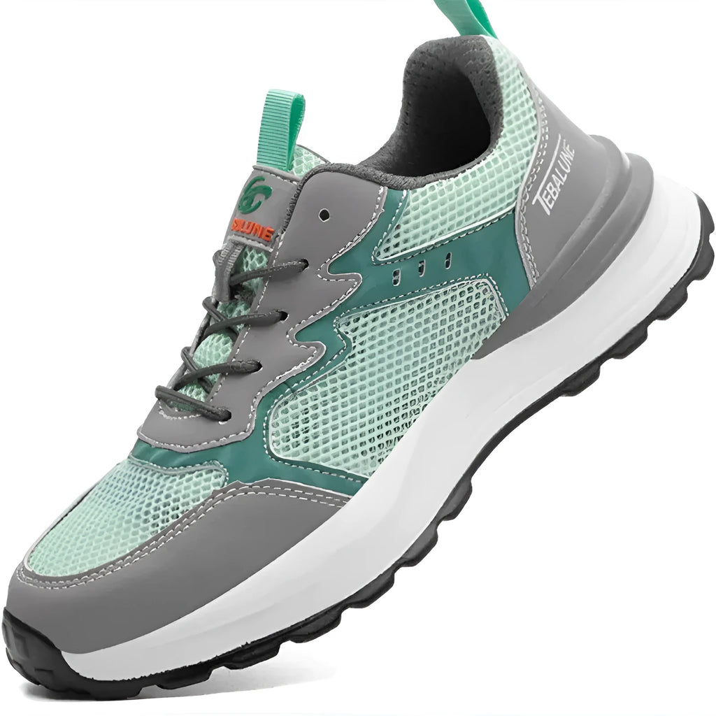 Green low-top work shoes with mesh upper, plastic steel toe cap, and slipper-style closure on a white background.