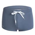 Men's solid colour lace nylon low waist swimming trunks on white background.