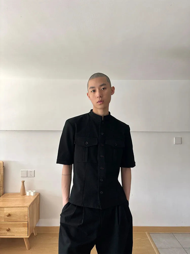 Black loose-fit half-sleeve hunting shirt with a shirt collar on a hanger.