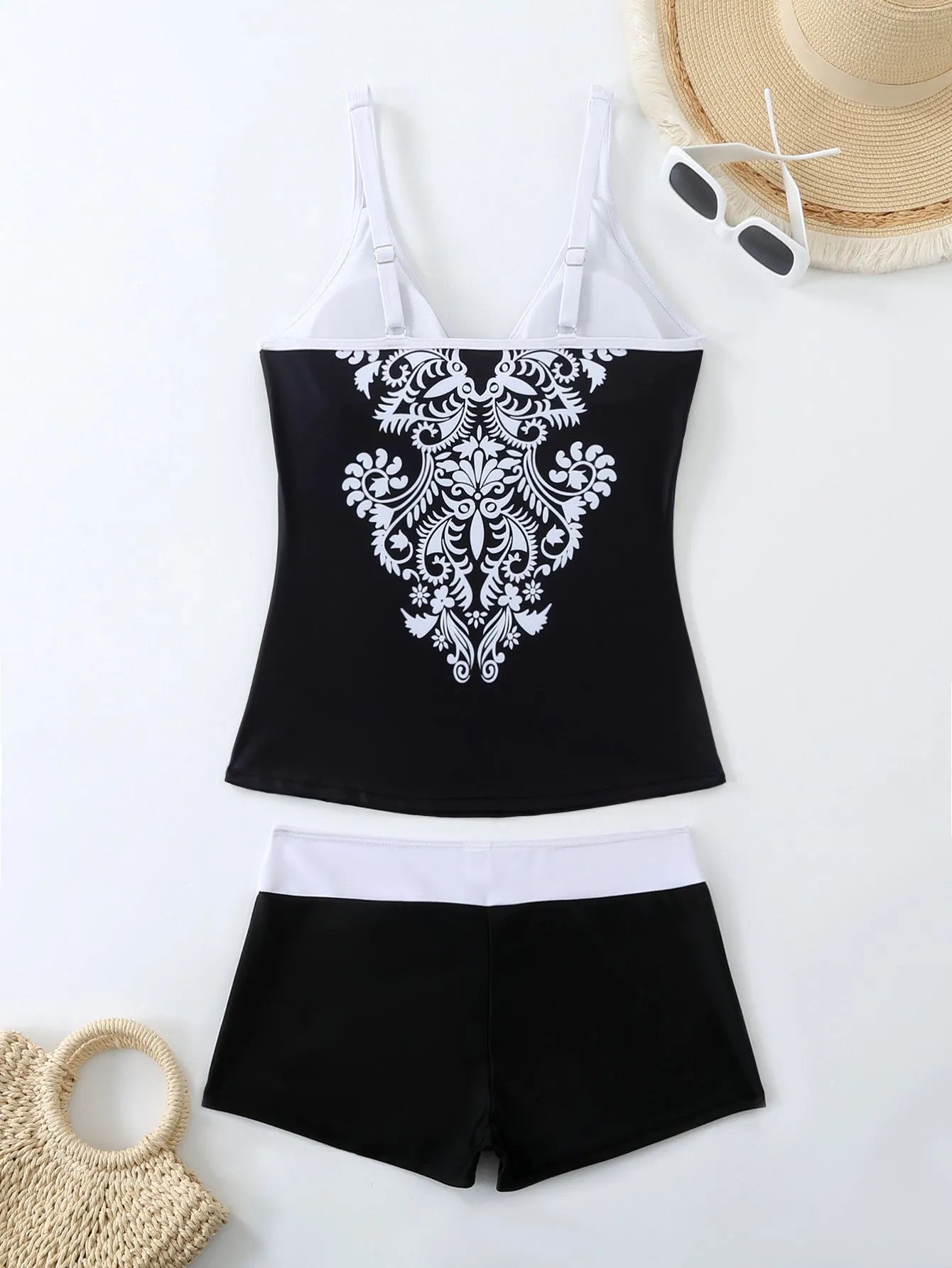 Plus size women's printed two-piece swimsuit in black or rose red with brief bottoms.