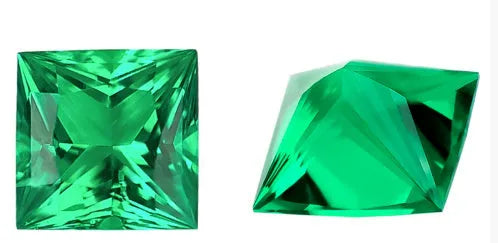 A loose cultivated emerald gemstone in a columbia green treasure colour on a white background.