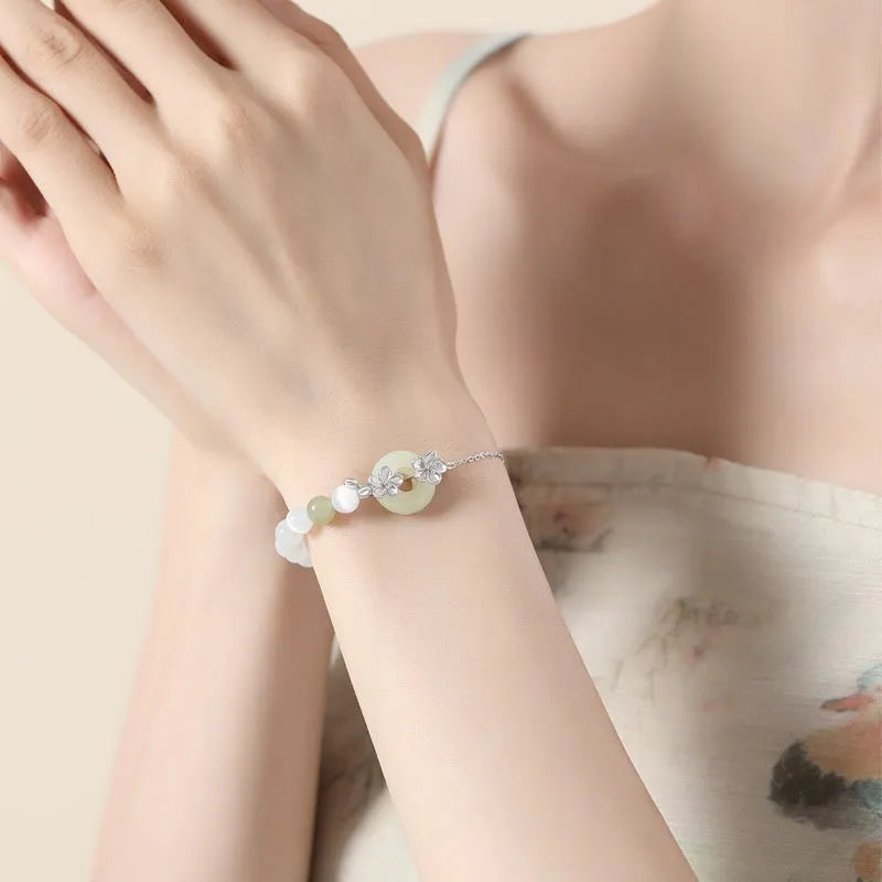 Pure silver peach blossom and safety buckle bracelet for women in New Chinese style, shown in electroplated gold tone.