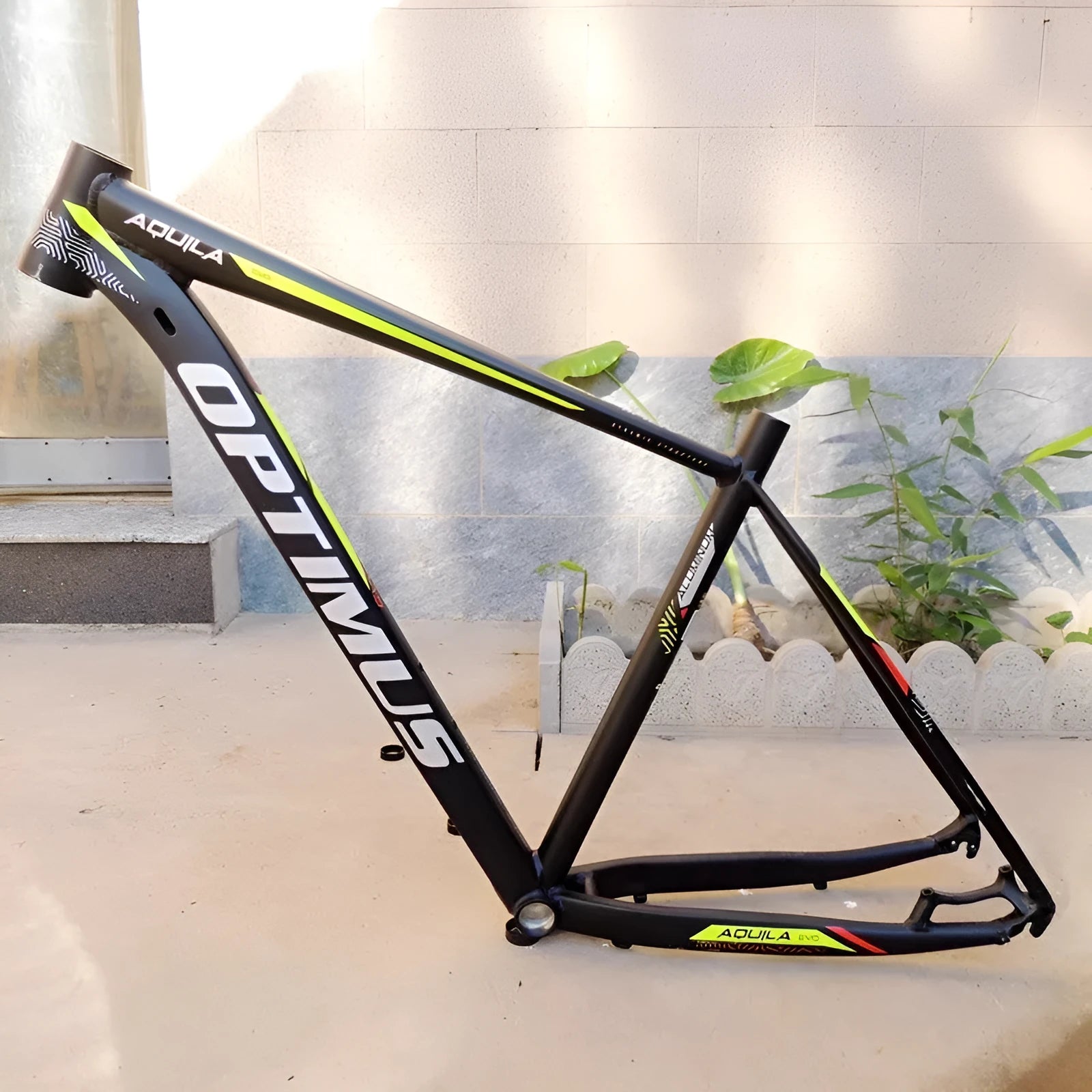 Black green aluminium mountain bike frame for 29-inch wheels with internal cable routing and disc brake mount.