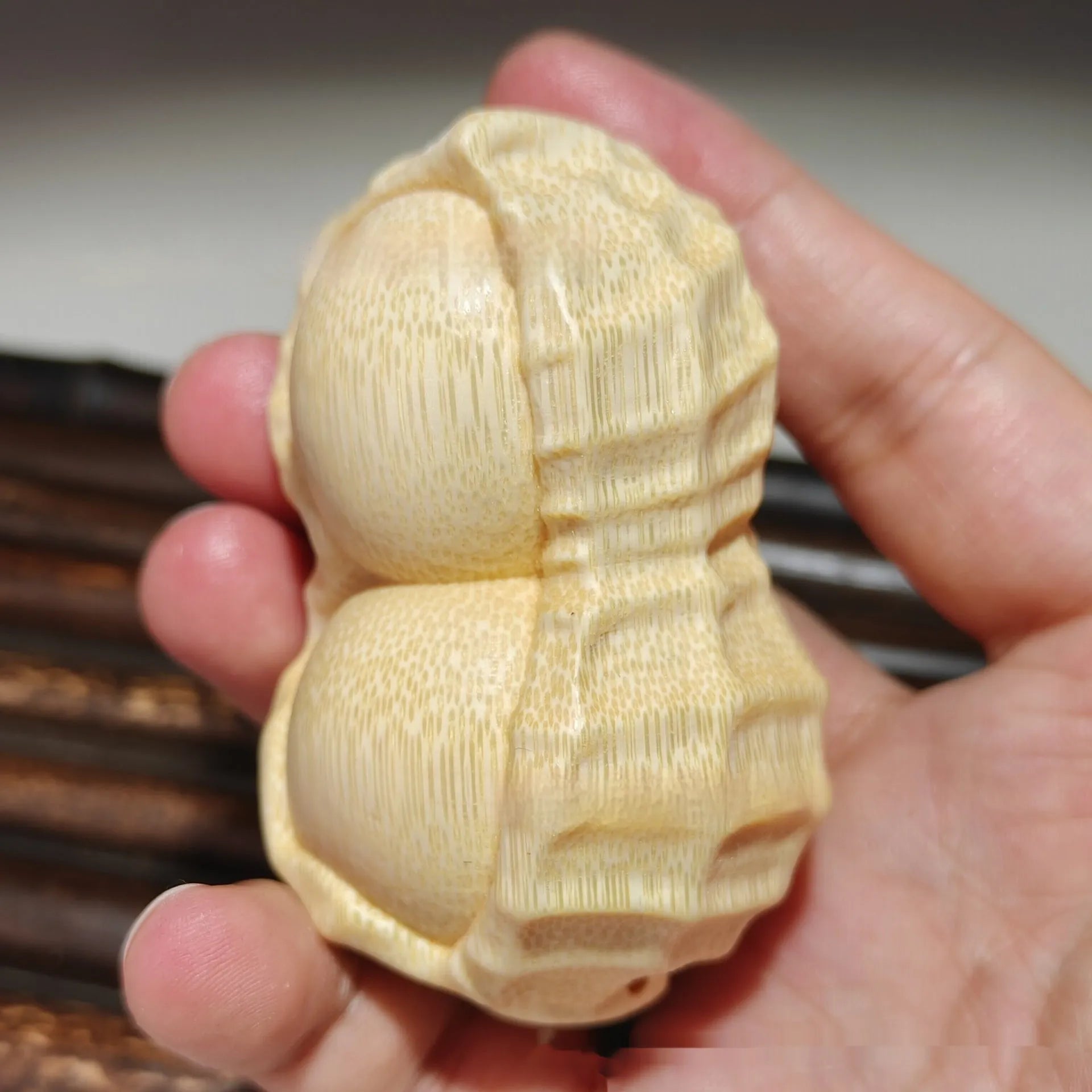 Solid bamboo carving peanut ornament on natural background