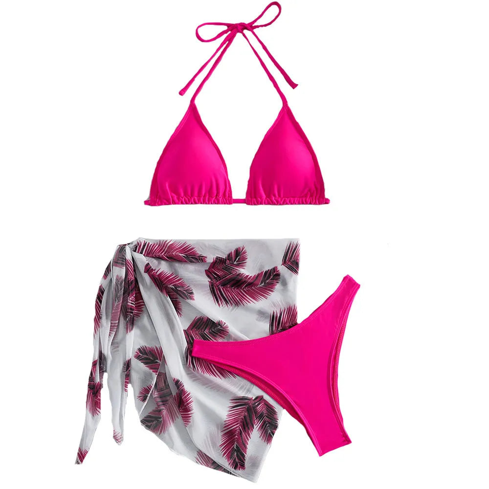 Women's orange polyester bikini set with a matching printed gauze skirt laid flat.