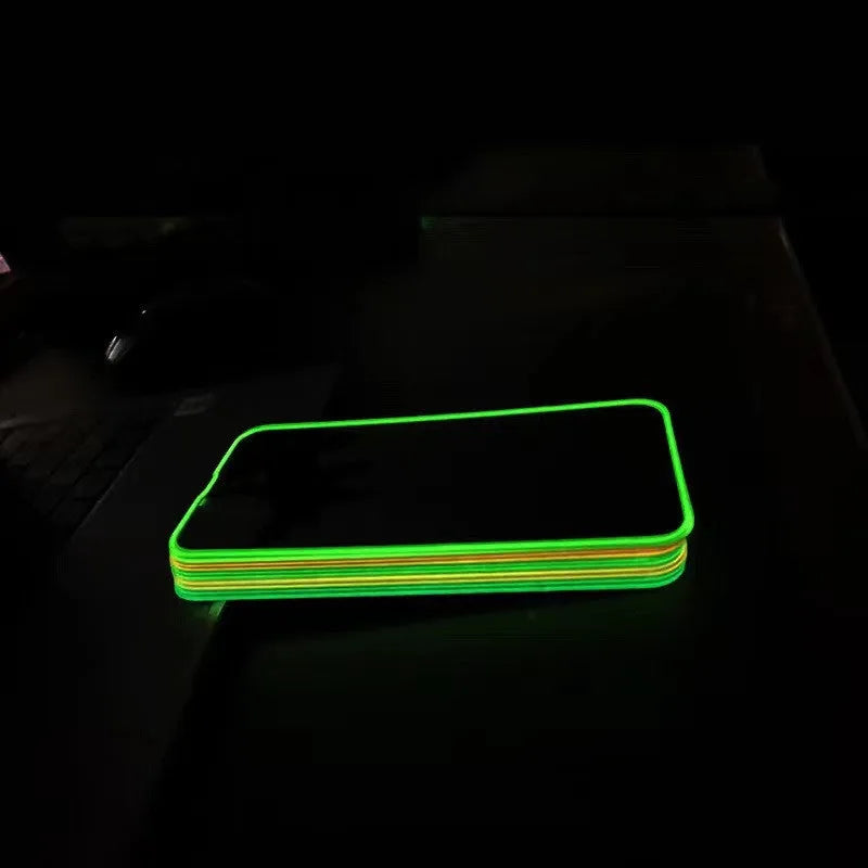 Fluorescent blue tempered glass screen protector glowing on an iPhone 13 in a dark setting.