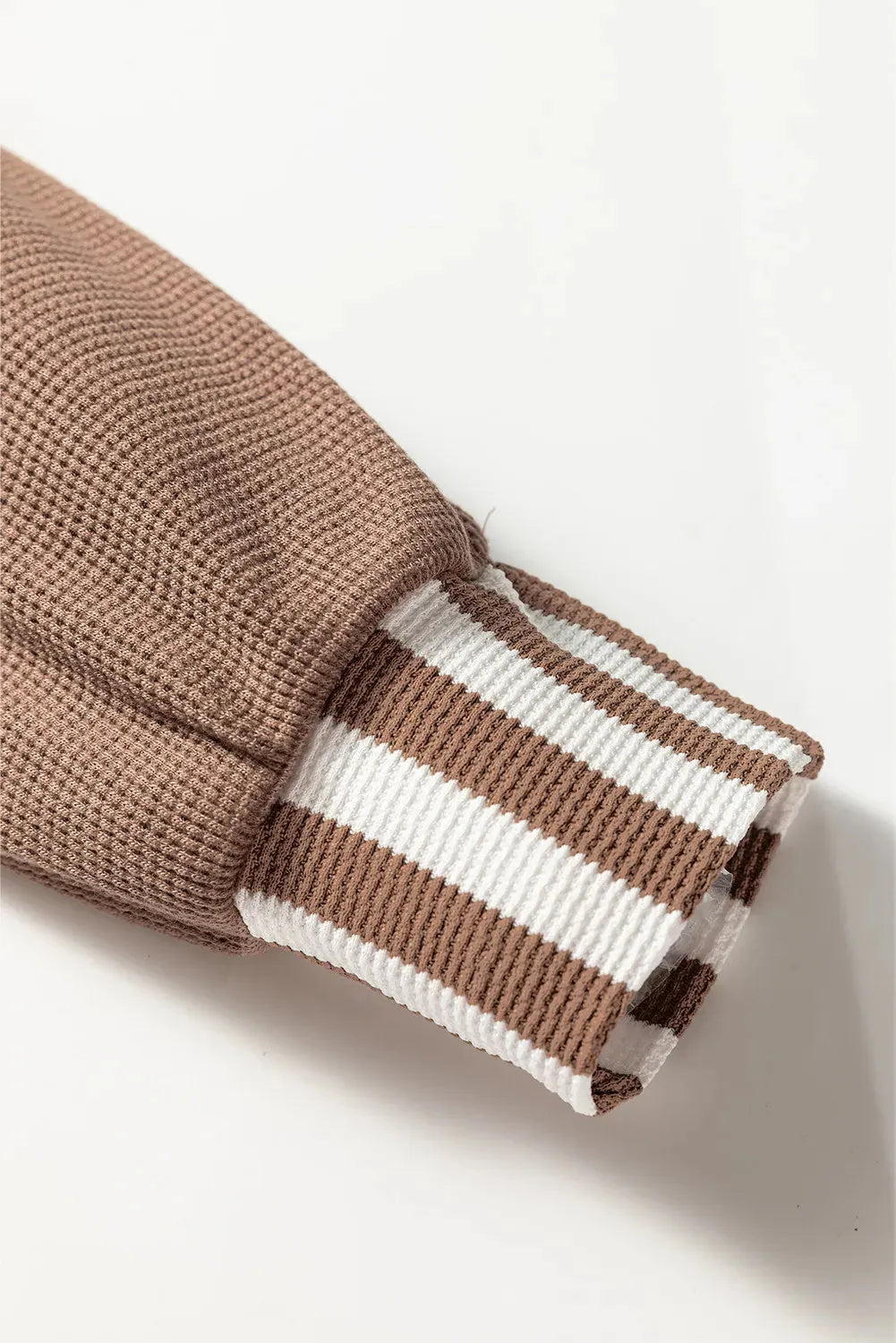 Straw yellow hoodie with waffle texture, striped patchwork, a button neck, and a drawstring hood.