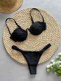 Women's black underwire bikini swimsuit with triangle top and briefs bottom on a mannequin.