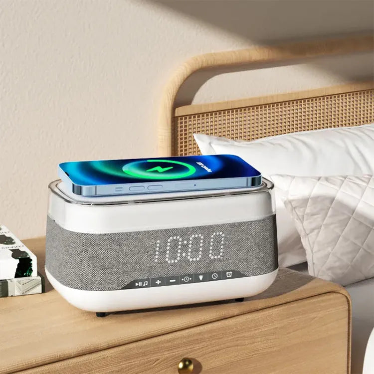 White multifunctional alarm clock with Bluetooth speaker and wireless charging pad on wooden table