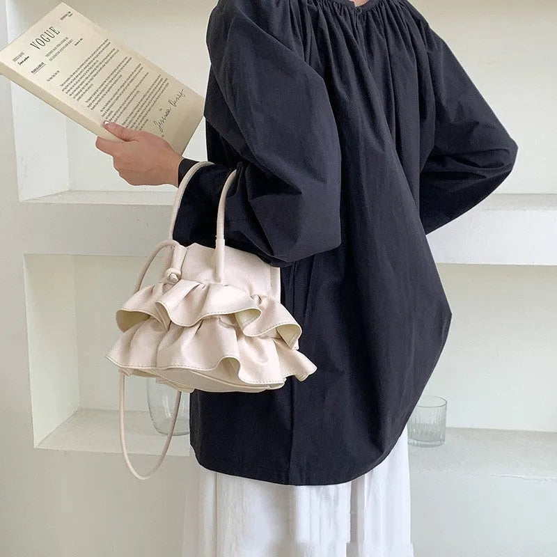 Bucket style PU folding shoulder bag in beige with open pocket for daily commute