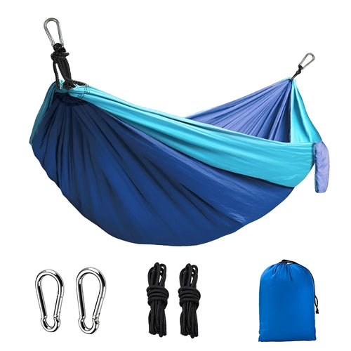 A sapphire blue double-layer nylon hammock hung between two trees, showing its full 270cm length and 140cm width.