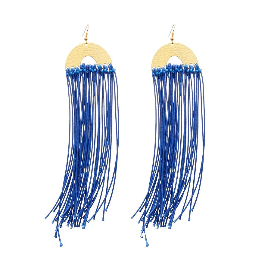 A pair of geometric cloth earrings with a blue resin flower decoration and silver needle detail.