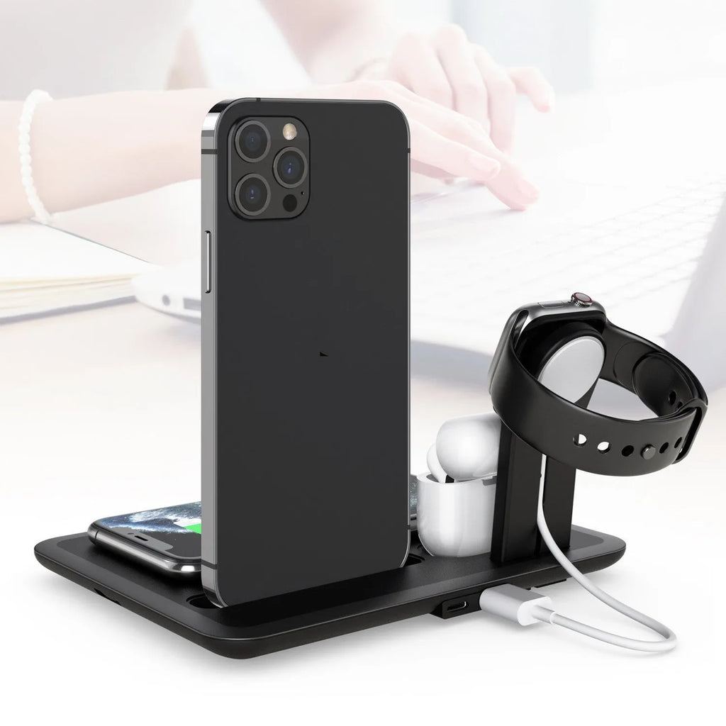 Black and white wireless charging desk stand holding a phone, smartwatch, and headphones.