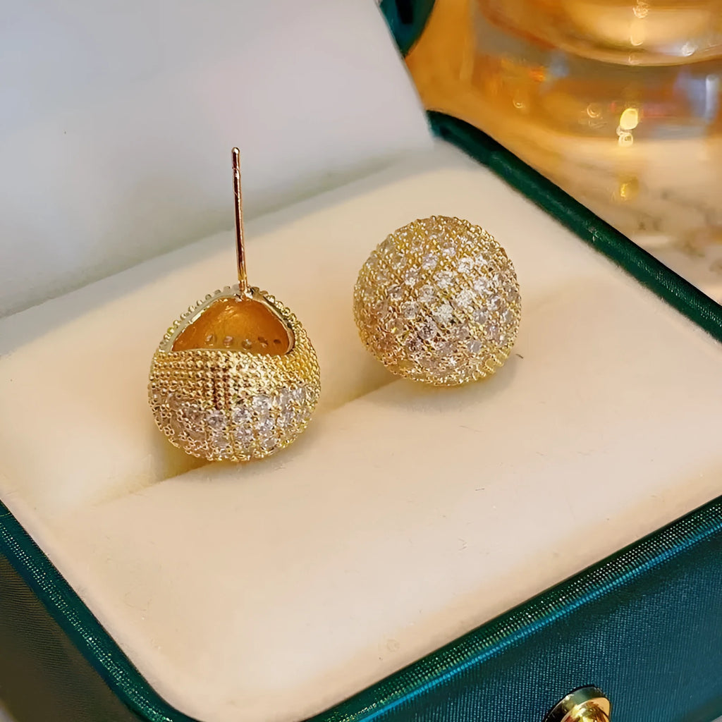 Gold and white drop-shaped geometric ear clip earrings with full diamond detailing and sphere elements