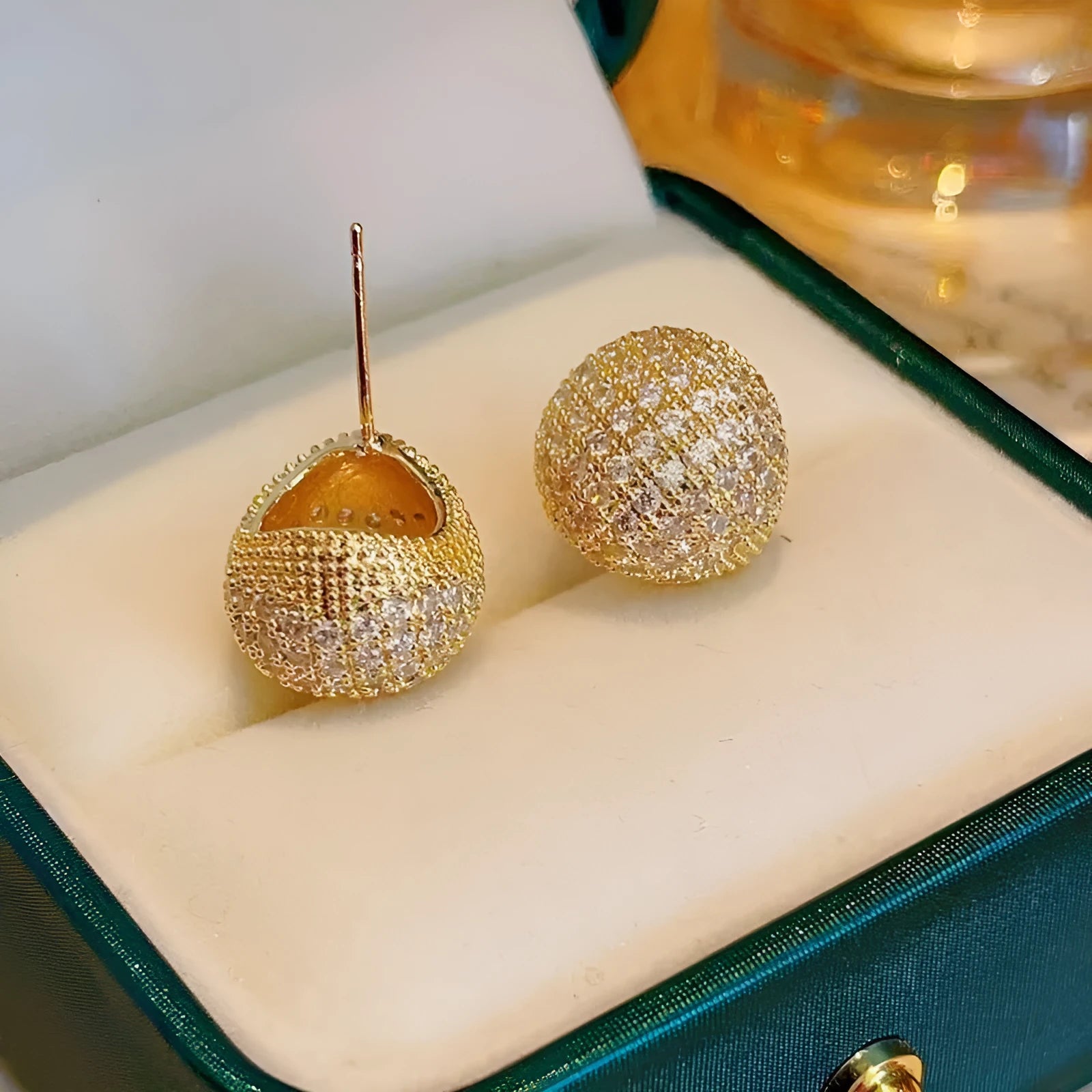 Gold and white drop-shaped geometric ear clip earrings with full diamond detailing and sphere elements