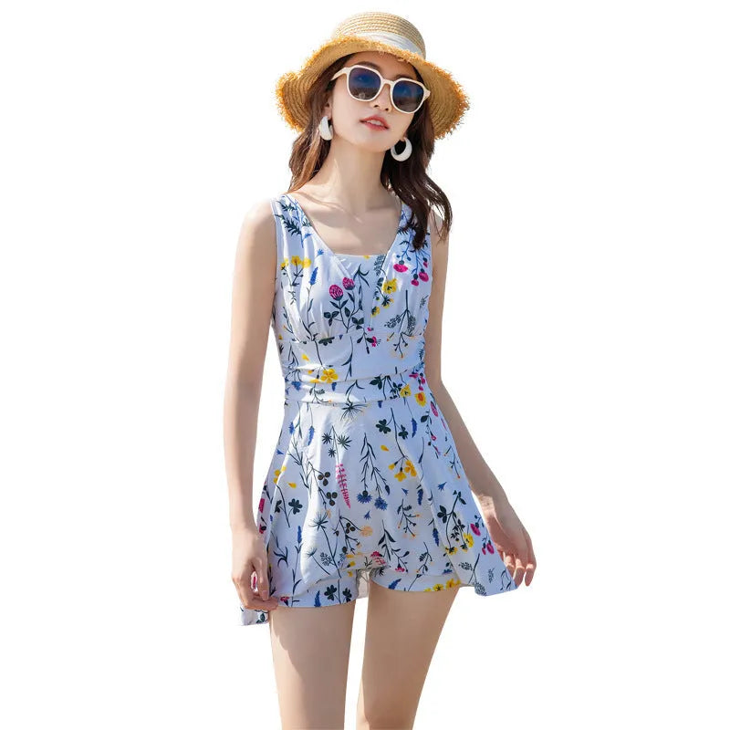 Women's lavender floral print one-piece swimsuit on a hanger.