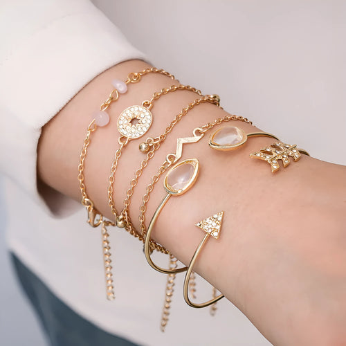 Gold zinc alloy bracelet set with water droplet and V-shaped designs for women.