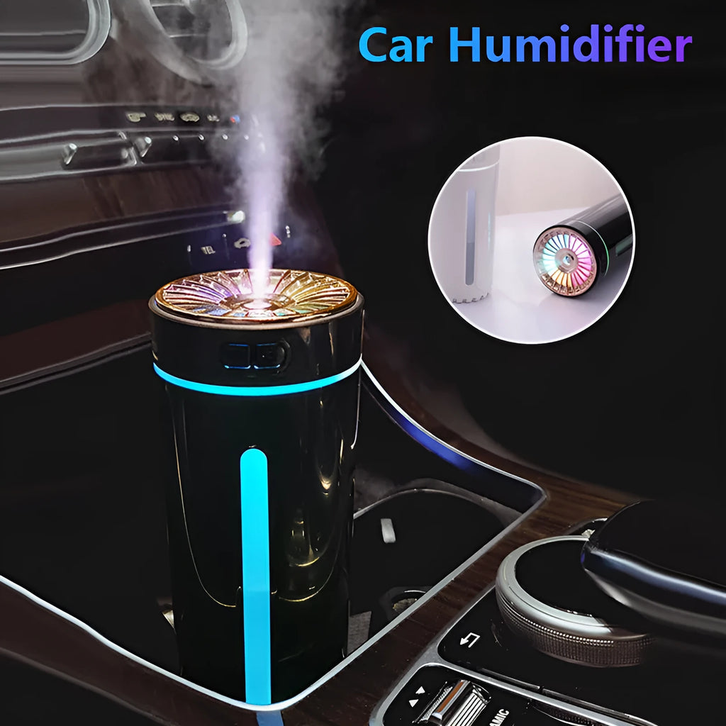 Black wireless USB car humidifier with colourful LED lights on a desktop next to a cup holder.