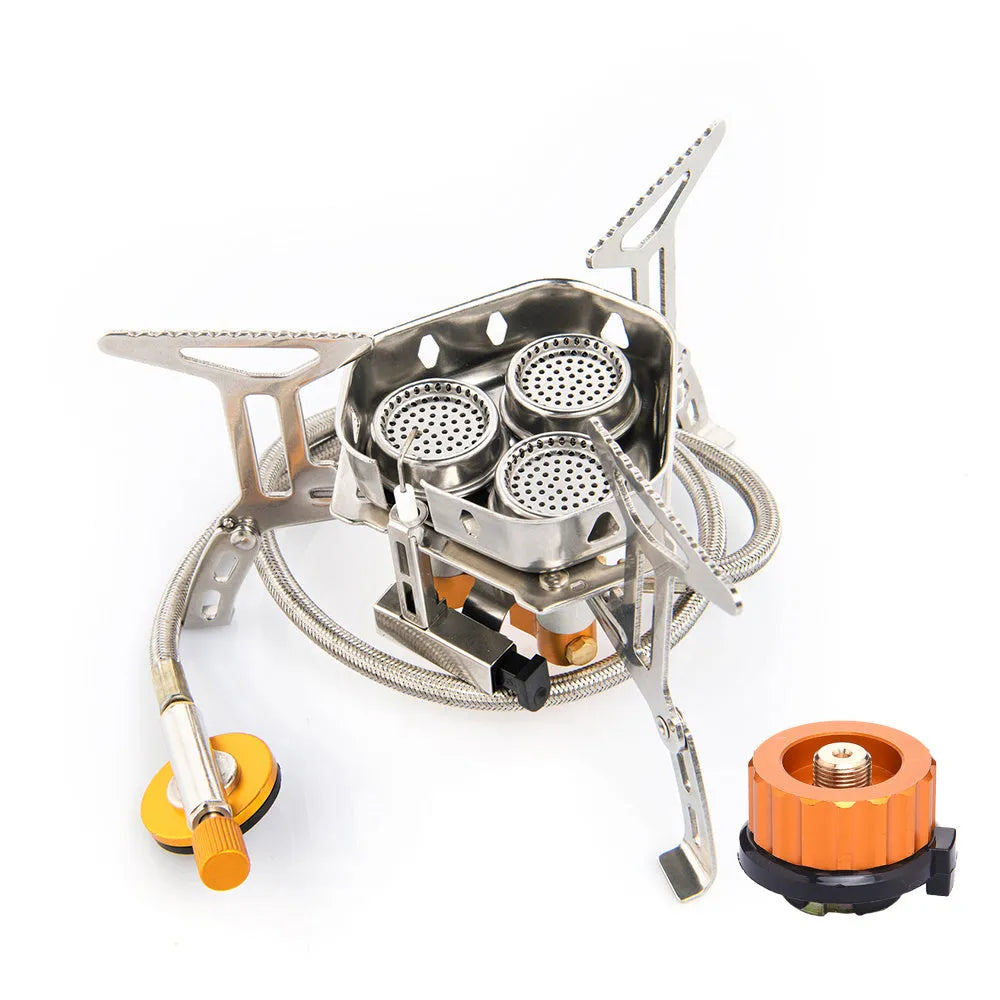Foldable portable windproof split camping stove with aluminium fire tray and stainless steel frame on outdoor surface