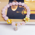 Pink crystal peach blossom bracelet with adjustable clasp on woman's wrist