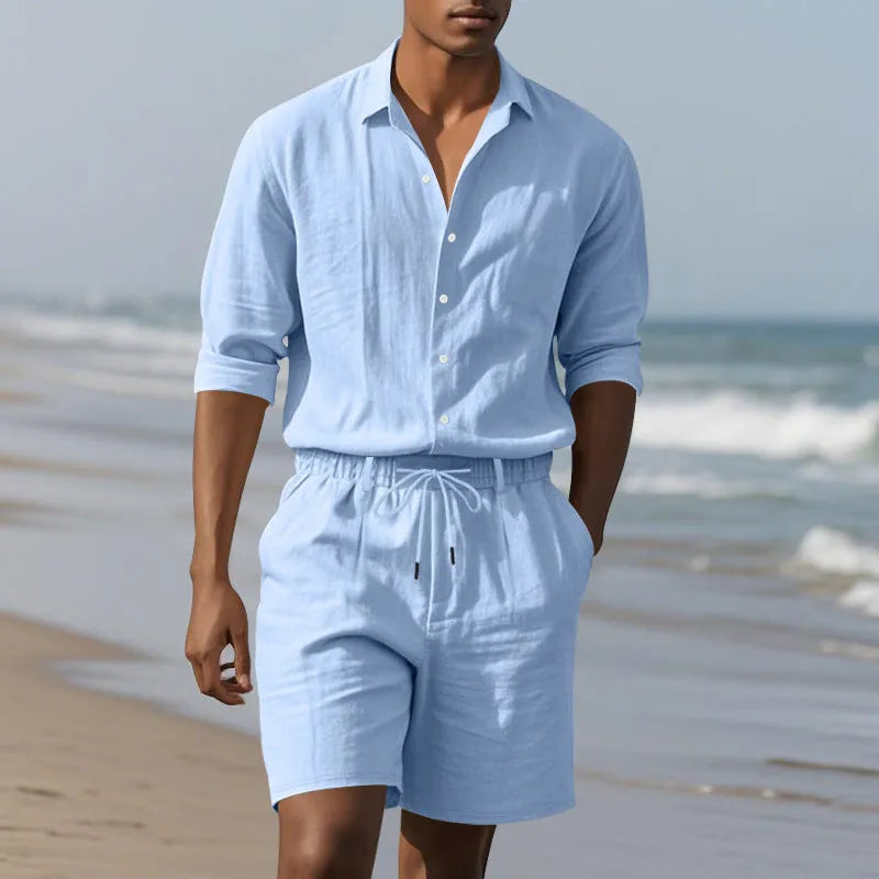 Men's linen beach suit consisting of a long sleeve shirt and shorts, shown in light blue colour.