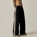 Black men's wide-leg climbing trousers with a high waist on a hanger.