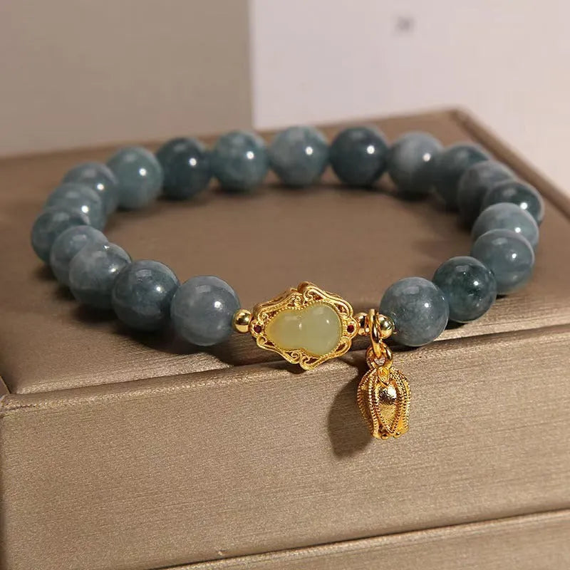 Natural stone bracelet for women with a blue electroplated gourd lotus flower pendant.
