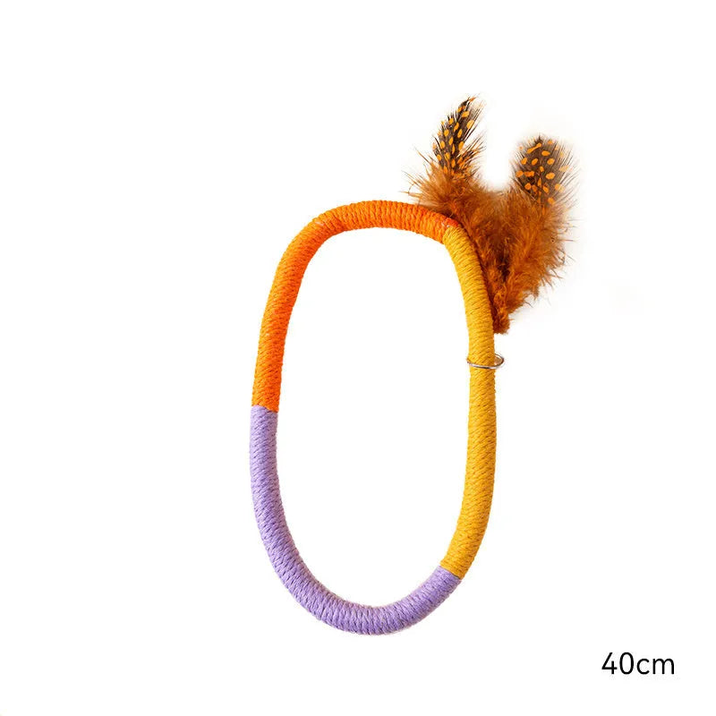 Green circular cotton rope cat toy with white feather attachments