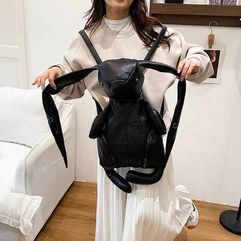 Black PU women's bucket backpack with double straps, patchwork stitching and internal phone, ID and hidden pockets
