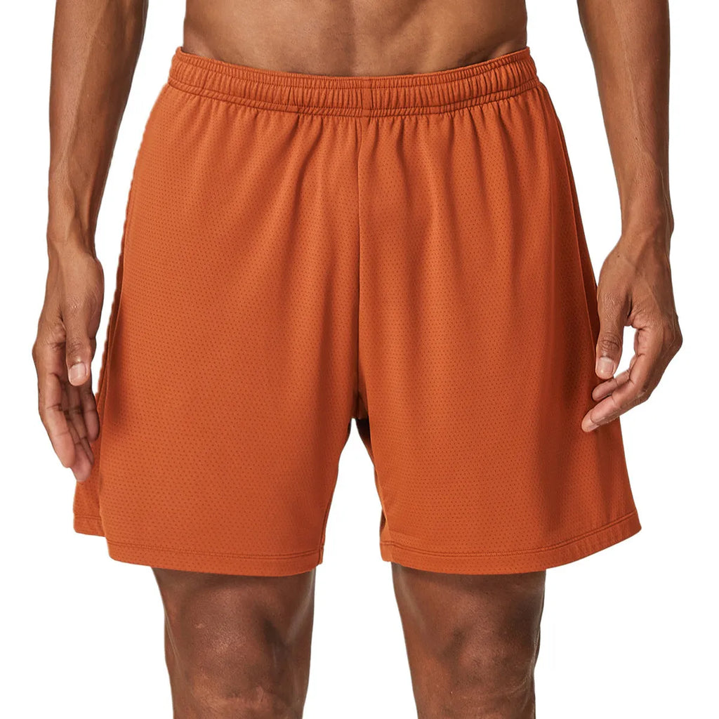 Man wearing brick red double-layer running shorts with a moisture-wicking fabric and inner compression liner.