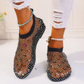 Women's colourful rhinestone flat sandals with mesh upper and rubber sole.